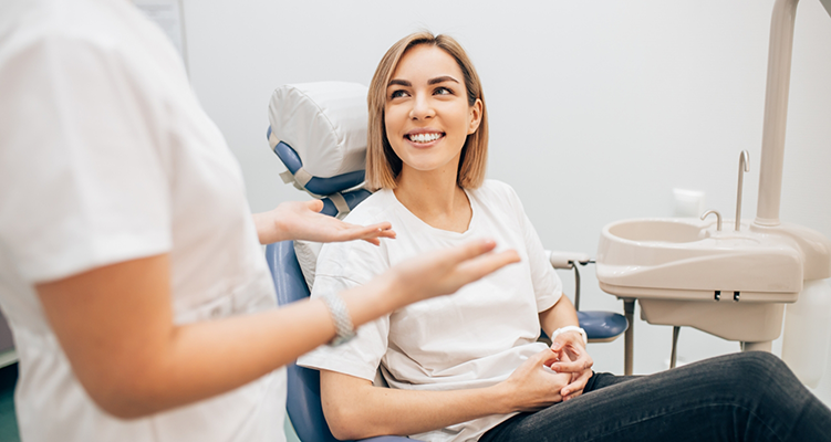 Woman in dental chair listening to her dentist in Wilmington