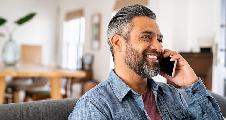 Smiling man talking on the phone with Wilmington dental office