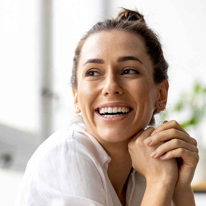 Smiling woman with her hair in a bun