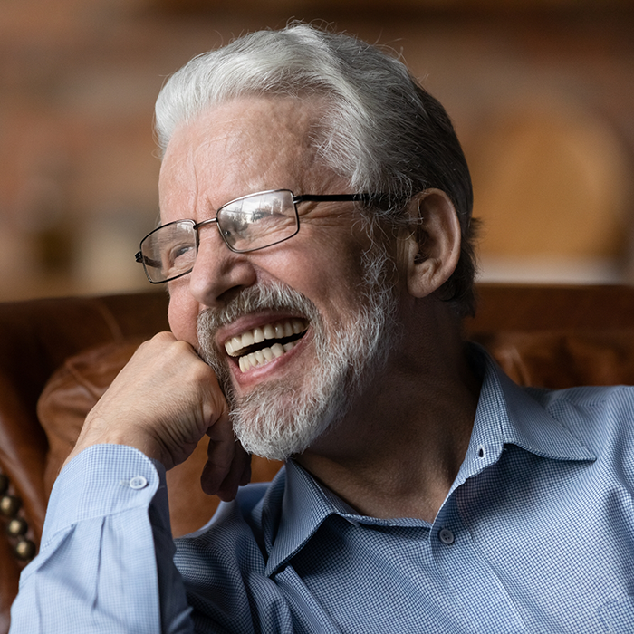 Senior man in glasses laughing