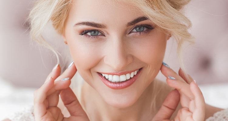 Blonde woman smiling after receiving dental services in Wilmington