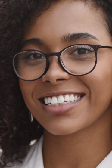 Young woman with glasses smiling