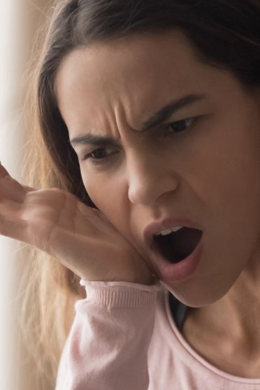 Woman holding the side of her jaw in pain