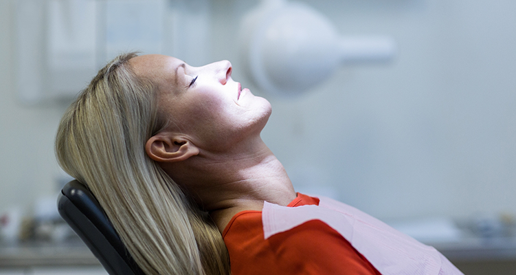 Woman relaxing in dental chair because of sedation dentistry in Wilmington